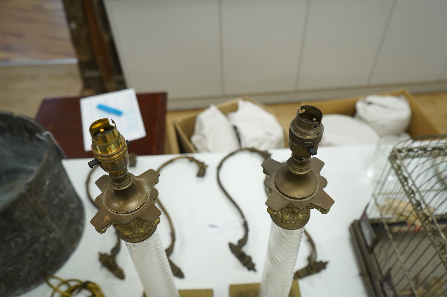A pair of brass and glass Corinthian column lamps, 59cm high overall